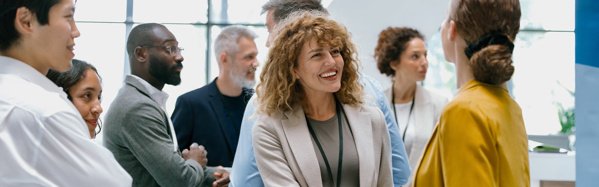 A group of people talking and smiling
